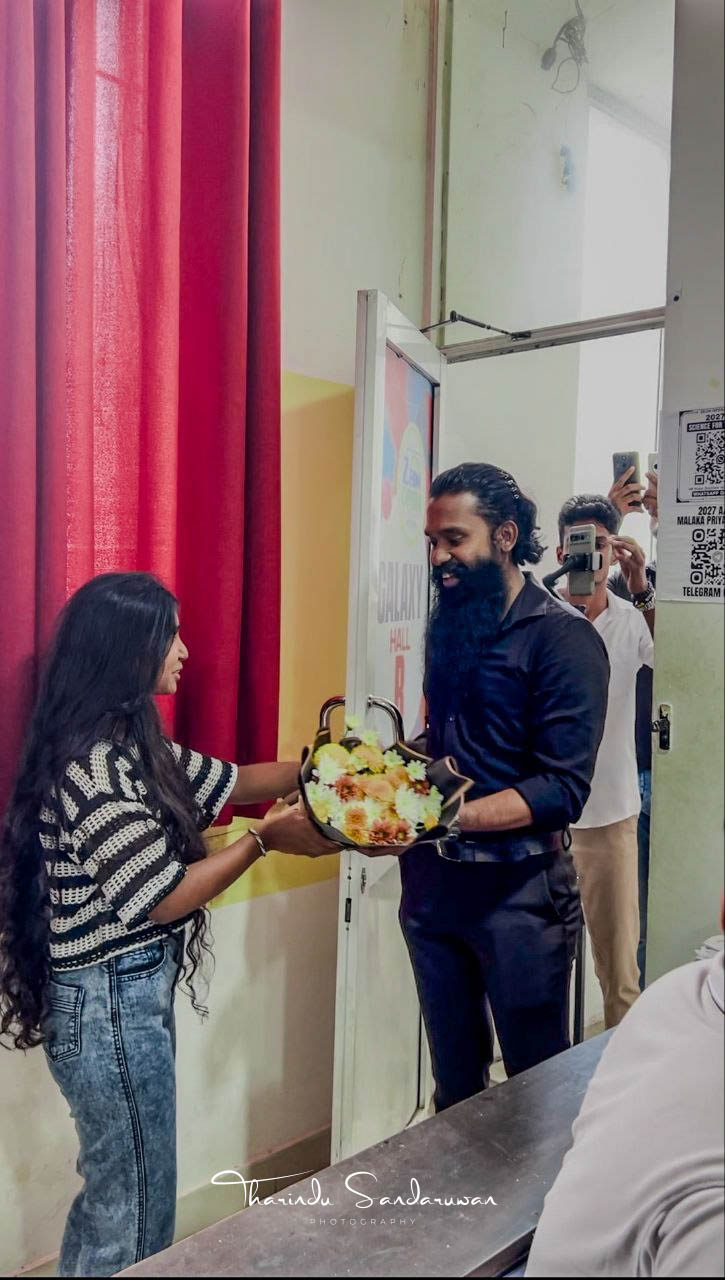 A woman presents a bouquet to a man at the birthday celebration.