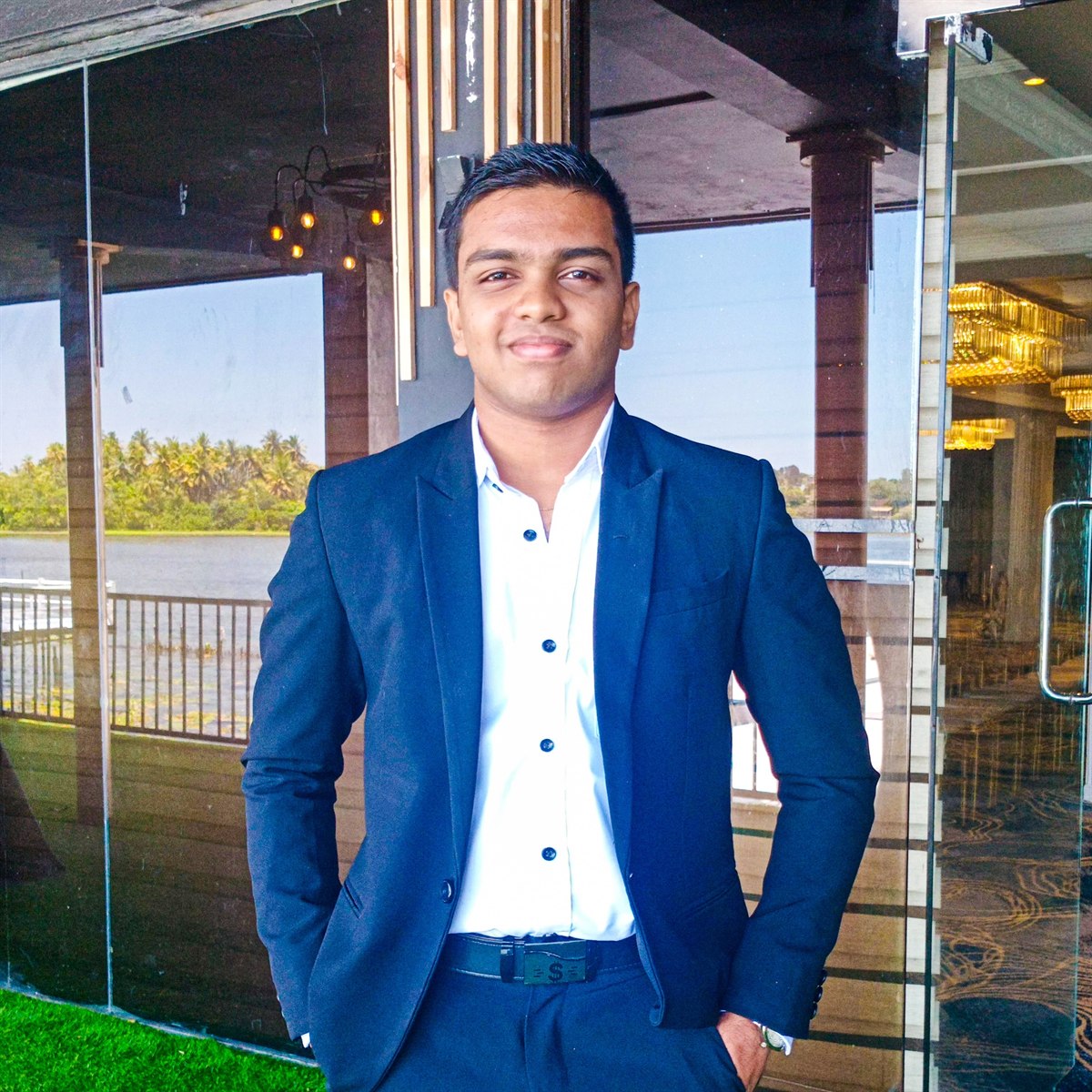 Tharindu Sandaruwan wearing a navy suit and white shirt.